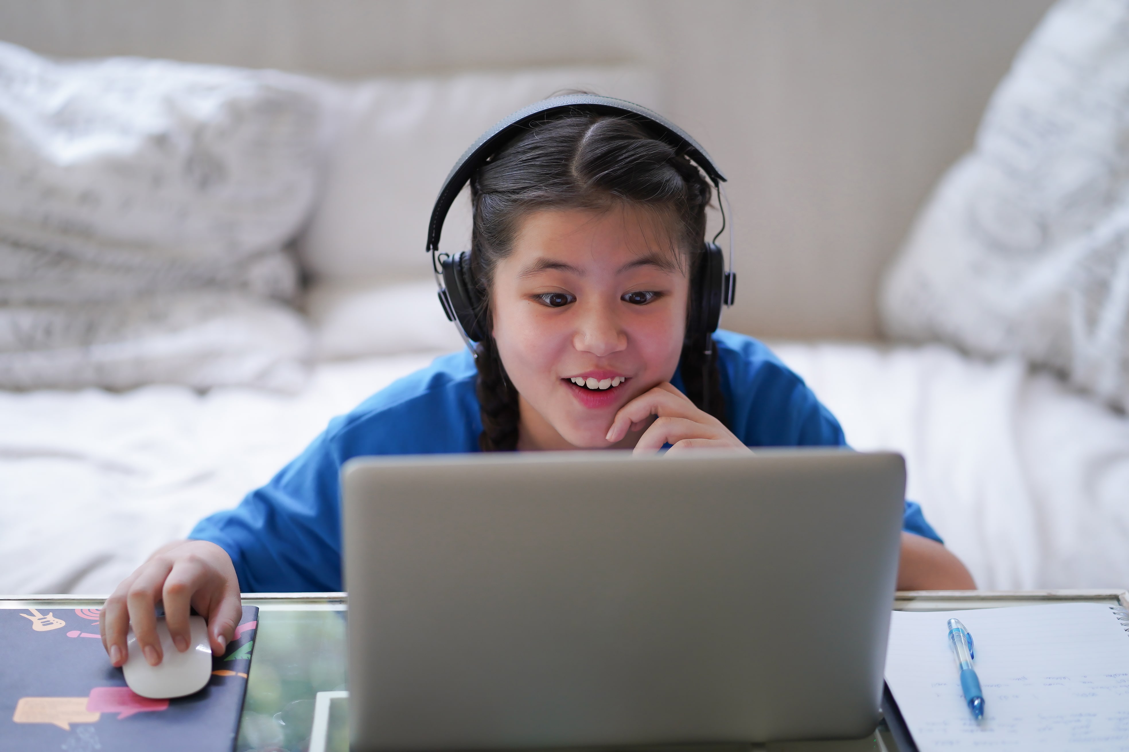 An excited student doing her online course