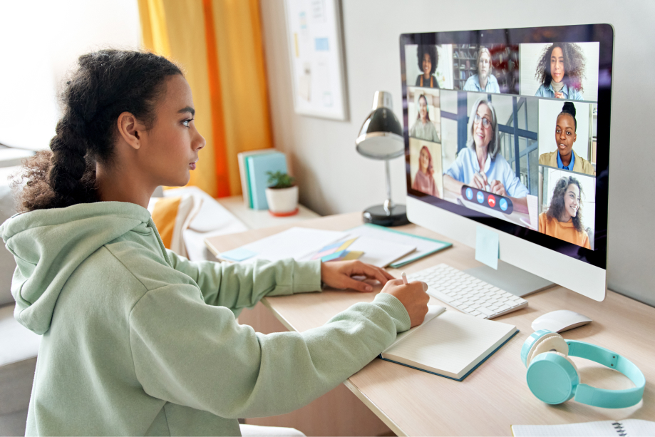 A young girl taking online lessons